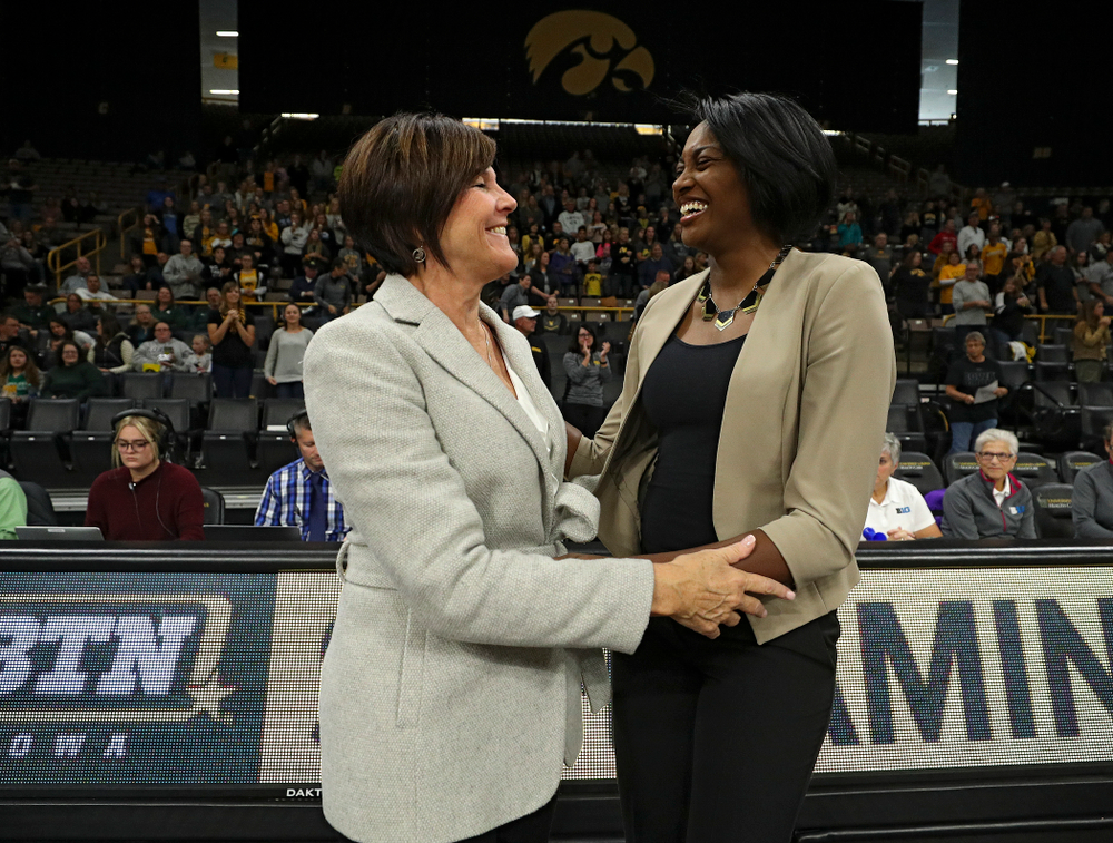 Michigan State head coach Cathy George (from left) and Iowa head coach Vicki Brown talk before the start of their volleyball match at Carver-Hawkeye Arena in Iowa City on Sunday, Oct 13, 2019. (Stephen Mally/hawkeyesports.com)