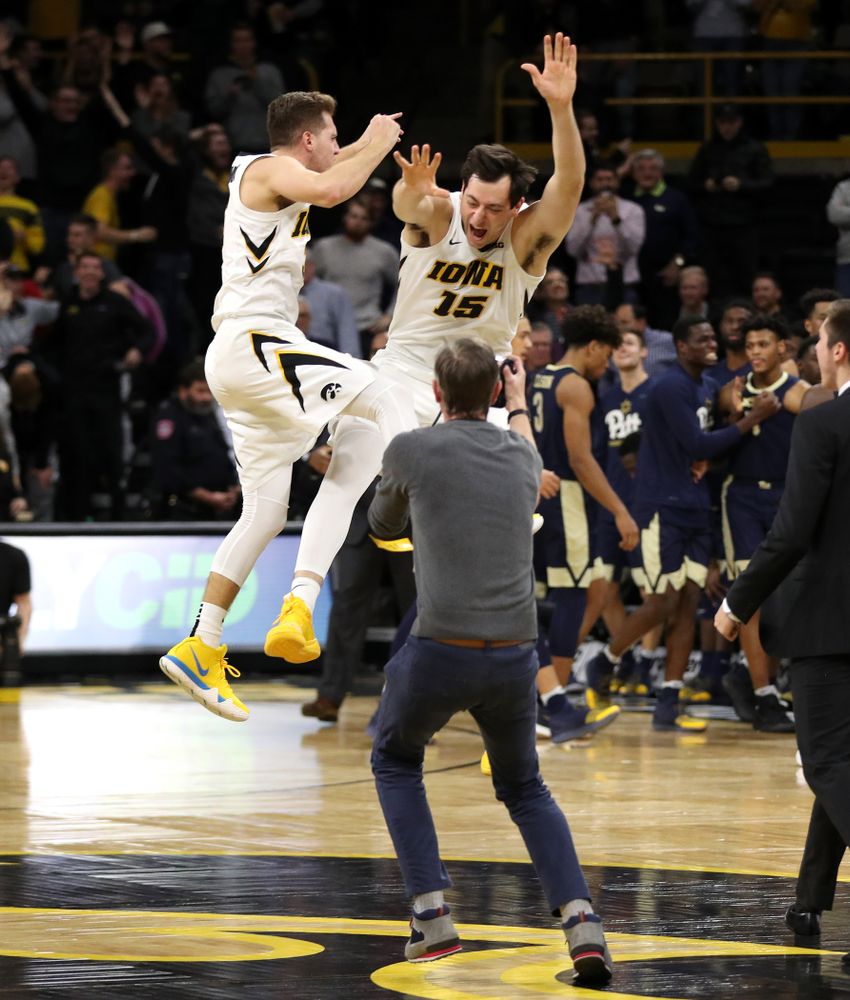 Iowa Hawkeyes guard Jordan Bohannon (3) and forward Ryan Kriener (15) celebrate their victory against the Pitt Panthers Tuesday, November 27, 2018 at Carver-Hawkeye Arena. (Brian Ray/hawkeyesports.com)