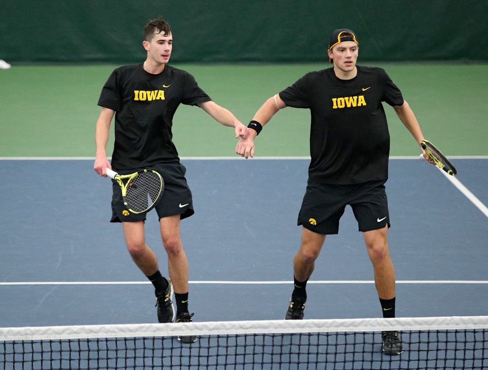 Iowa’s Matt Clegg (from left) and Joe Tyler celebrate a point during their doubles match against Marquette at the Hawkeye Tennis and Recreation Complex in Iowa City on Saturday, January 25, 2020. (Stephen Mally/hawkeyesports.com)