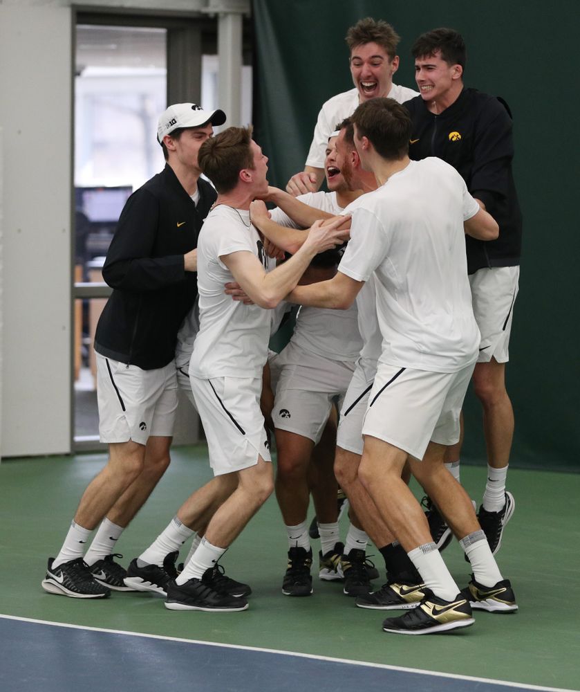 Iowa’s Will Davies celebrates with his teammates after defeating Cornell’s Lev Kazakov in three sets to clench at 4-3 victory Sunday, March 8, 2020 at the Hawkeye Tennis and Recreation Center. (Brian Ray/hawkeyesports.com)