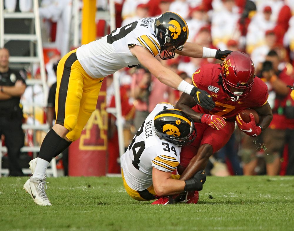 Iowa Hawkeyes linebacker Nick Niemann (49) and linebacker Kristian Welch (34) make a tackle during the first quarter of their Iowa Corn Cy-Hawk Series game at Jack Trice Stadium in Ames on Saturday, Sep 14, 2019. (Stephen Mally/hawkeyesports.com)