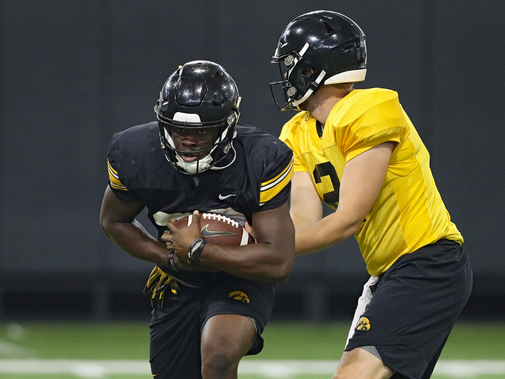 Iowa Hawkeyes running back Shadrick Byrd (23) takes a handoff from quarterback Peyton Mansell (2) during Fall Camp Practice No. 9 at the Hansen Football Performance Center in Iowa City on Monday, Aug 12, 2019. (Stephen Mally/hawkeyesports.com)