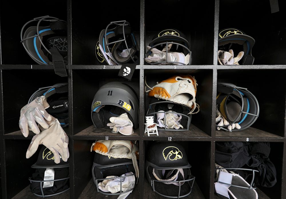 Batting helmets and gloves sit in the Iowa dugout before their game against Illinois at Pearl Field in Iowa City on Friday, Apr. 12, 2019. (Stephen Mally/hawkeyesports.com)