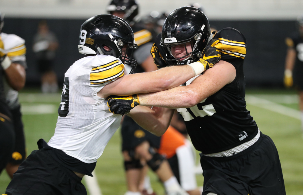 Iowa Hawkeyes tight end Shaun Beyer (42) in blocks drill vs. Iowa Hawkeyes linebacker Nick Niemann (49)