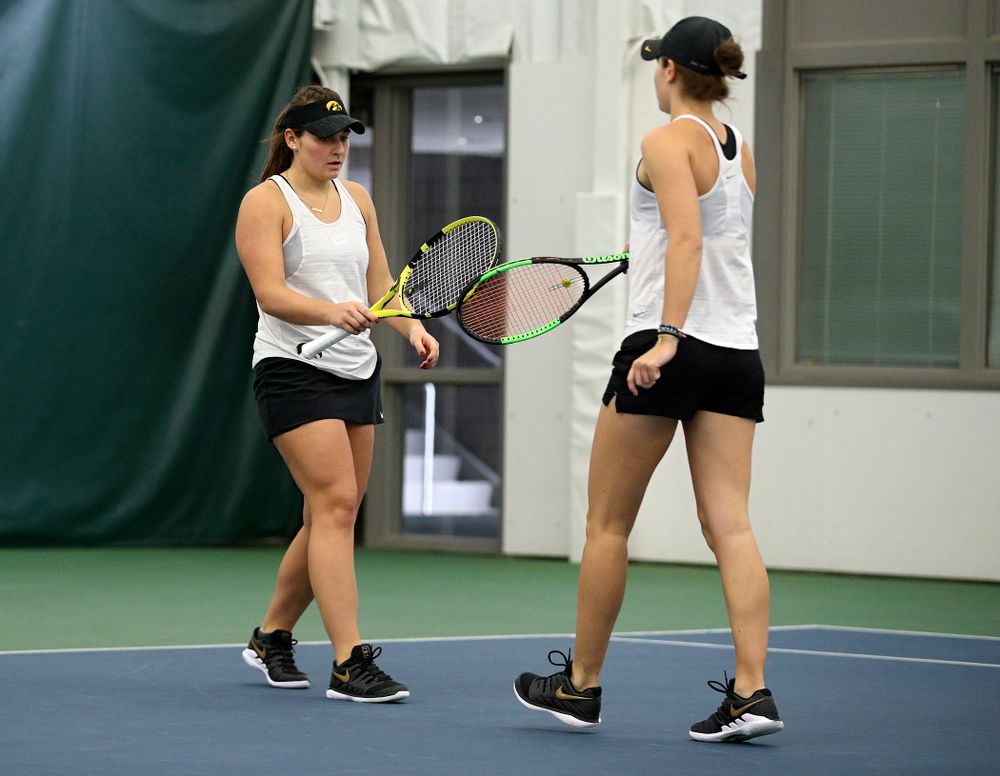 Iowa’s Danielle Bauers (from left) celebrates with Elise Van Heuvelen during their doubles match at the Hawkeye Tennis and Recreation Complex in Iowa City on Sunday, February 23, 2020. (Stephen Mally/hawkeyesports.com)
