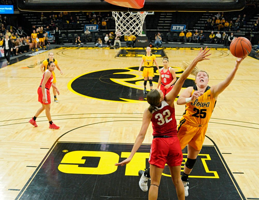 Iowa Hawkeyes forward Monika Czinano (25) scores a basket around Ohio State Buckeyes forward Aaliyah Patty (32) during the first quarter of their game at Carver-Hawkeye Arena in Iowa City on Thursday, January 23, 2020. (Stephen Mally/hawkeyesports.com)