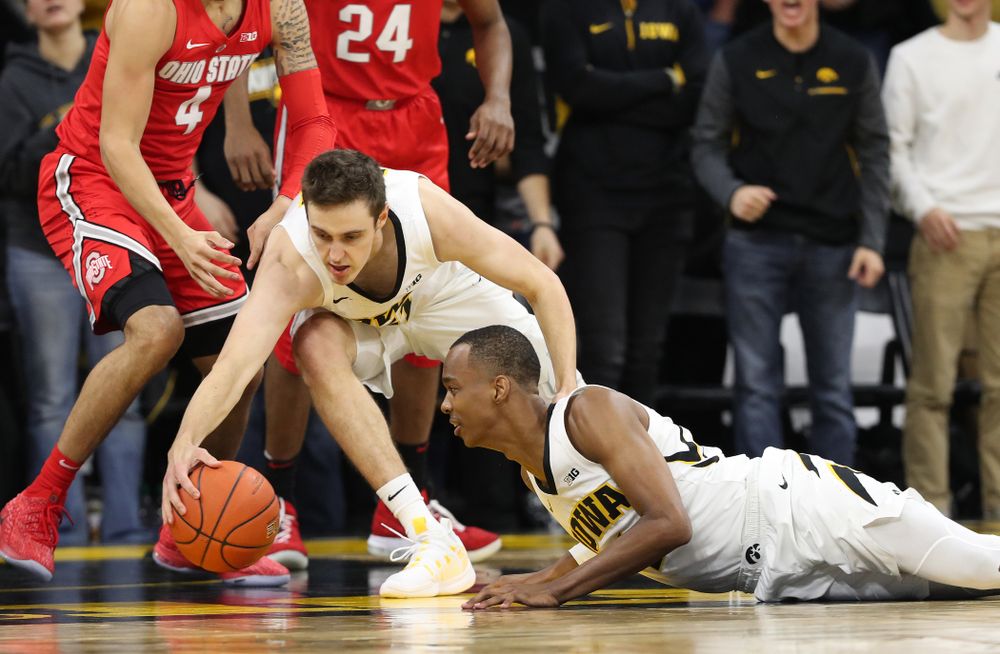 Iowa Hawkeyes forward Nicholas Baer (51) and guard Maishe Dailey (1) battle for a loose ball against the Ohio State Buckeyes Saturday, January 12, 2019 at Carver-Hawkeye Arena. (Brian Ray/hawkeyesports.com)