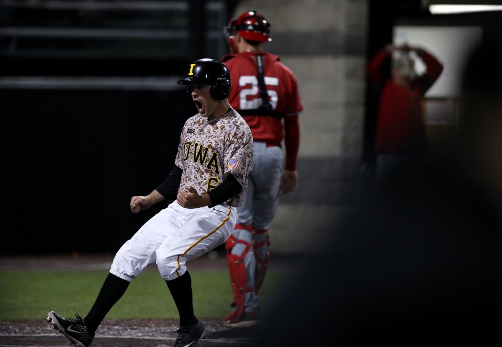 Iowa Hawkeyes outfielder Justin Jenkins (6) scores the game winning run in the bottom of the 9th against the Nebraska Cornhuskers on Military Appreciation Night Friday, April 19, 2019 at Duane Banks Field. (Brian Ray/hawkeyesports.com)