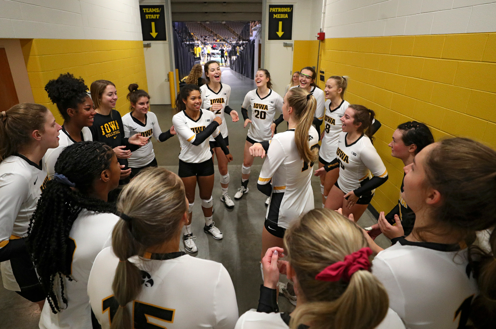 Iowa’s Brie Orr (7) and Hannah Clayton (18) dance as their team huddles before the start of their volleyball match at Carver-Hawkeye Arena in Iowa City on Sunday, Oct 13, 2019. (Stephen Mally/hawkeyesports.com)