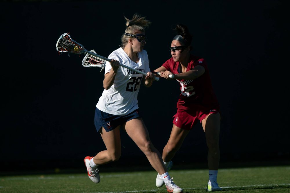 STANFORD, California - FEBRUARY 14: Virginia Cavaliers midfield Nora Bowen (28) is defended by Stanford Cardinal midfield Daniella McMahon (32) during the first half at Cagan Stadium on February 14, 2020 in Stanford, California. The Virginia Cavaliers defeated the Stanford Cardinal 12-11. (Photo by Jason O. Watson)