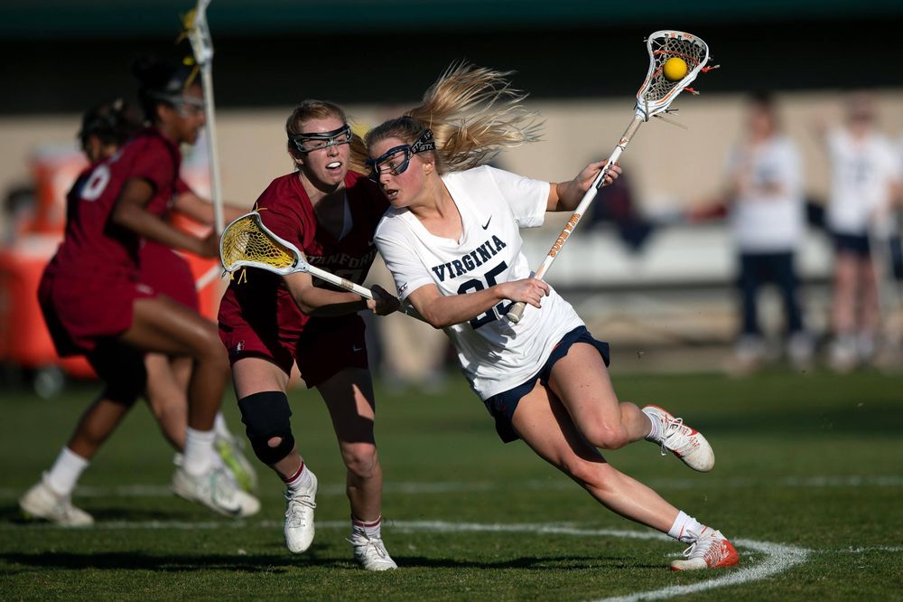 STANFORD, California - FEBRUARY 14: Virginia Cavaliers midfield Courtlynne Caskin (25) is defended by Stanford Cardinal attack Kelleigh Keating (23) during the first half at Cagan Stadium on February 14, 2020 in Stanford, California. The Virginia Cavaliers defeated the Stanford Cardinal 12-11. (Photo by Jason O. Watson)
