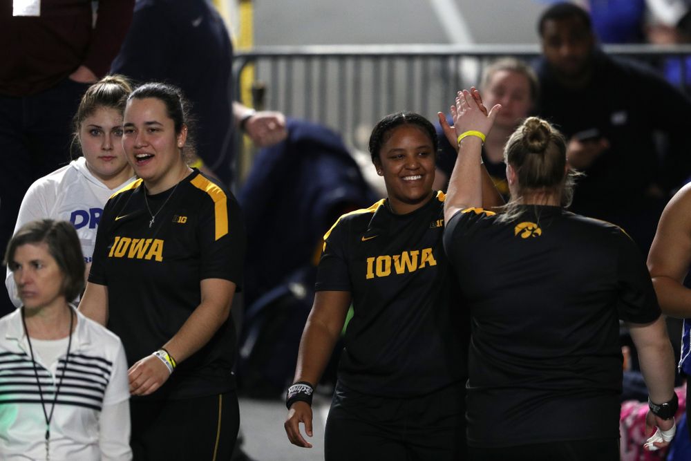 Iowa's Nia Britt high fives Erika Hammond as they compete in the Shot Put during the Black and Gold Premier meet Saturday, January 26, 2019 at the Recreation Building. (Brian Ray/hawkeyesports.com)