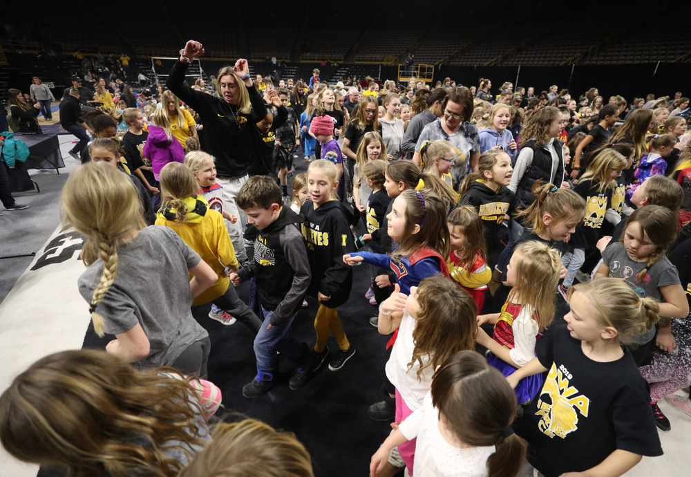 Iowa Women's Basketball seniors Megan Gustafson, Tania Davis, and forward Hannah Stewart (21) present the awards and dance the Cha Cha Slide following the Gymhawks meet against Illinois Saturday, February 16, 2019 at Carver-Hawkeye Arena. (Brian Ray/hawkeyesports.com)