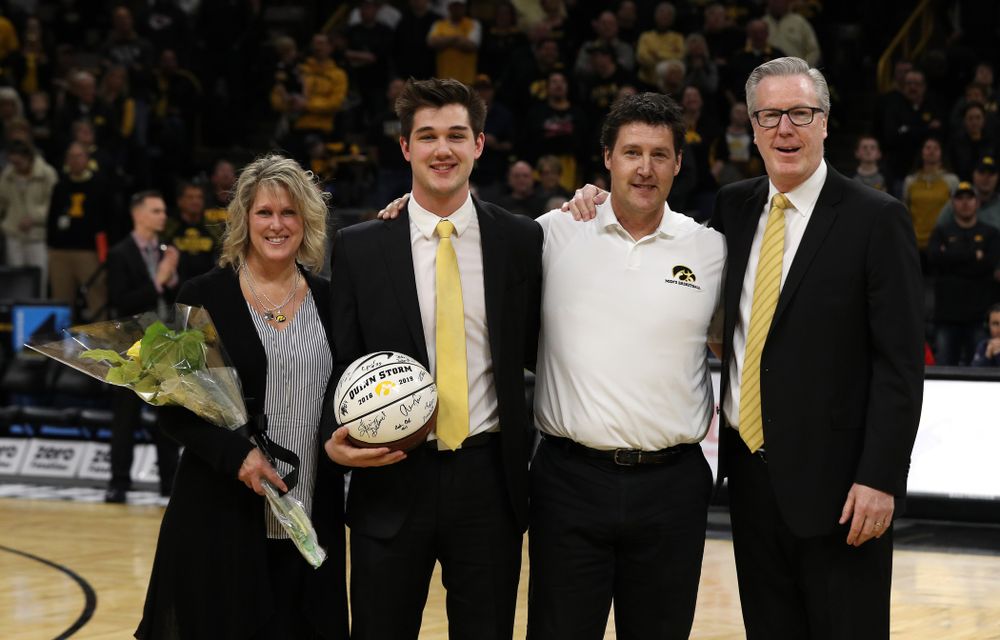 Senior Manager Quinn Storm stands with Iowa Hawkeyes head coach Fran McCaffery and his family during senior day activities before their game against the Rutgers Scarlet Knights Saturday, March 2, 2019 at Carver-Hawkeye Arena. (Brian Ray/hawkeyesports.com)
