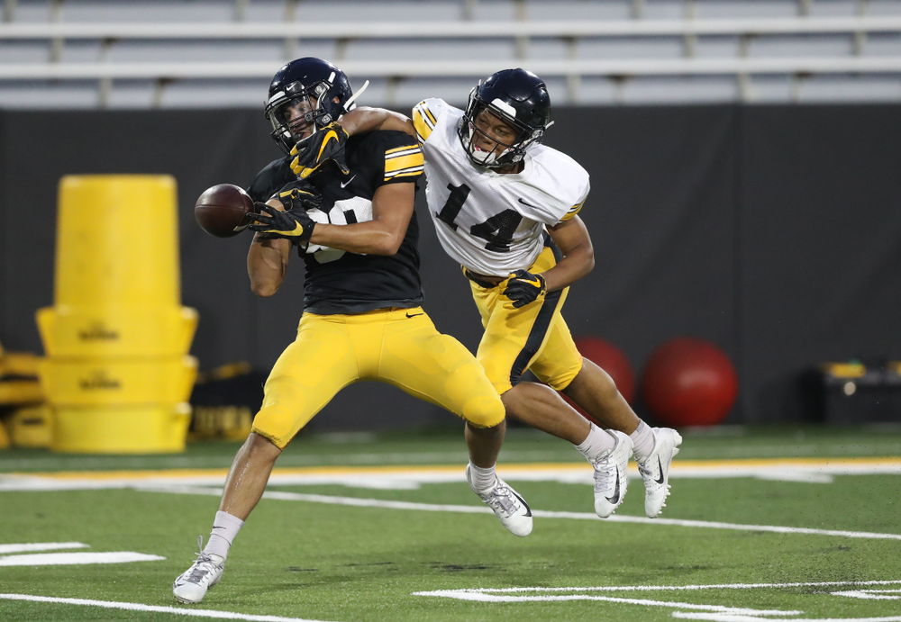 Iowa Hawkeyes defensive back Daraun McKinney (14) breaks up a pass intended for Iowa Hawkeyes wide receiver Nico Ragaini (89)