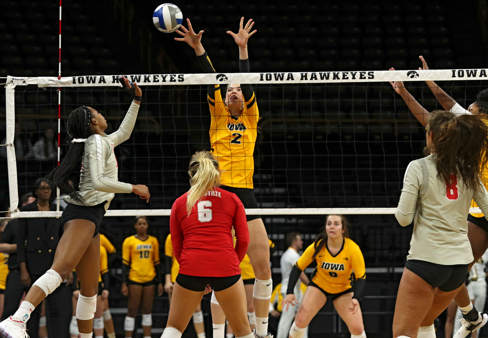 Iowa’s Courtney Buzzerio (2) gets her hands on a shot during the first set of their match at Carver-Hawkeye Arena in Iowa City on Friday, Nov 29, 2019. (Stephen Mally/hawkeyesports.com)