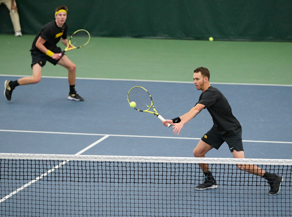 Iowa’s Kareem Allaf (right) hits a shot as Nikita Snezhko looks on during their doubles match against Marquette at the Hawkeye Tennis and Recreation Complex in Iowa City on Saturday, January 25, 2020. (Stephen Mally/hawkeyesports.com)