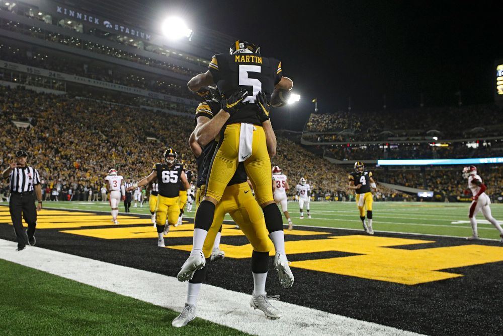 Iowa Hawkeyes tight end Shaun Beyer (42) lfits wide receiver Oliver Martin (5) after he caught a 9-yard touchdown reception during the third quarter of their game at Kinnick Stadium in Iowa City on Saturday, Aug 31, 2019. (Stephen Mally/hawkeyesports.com)