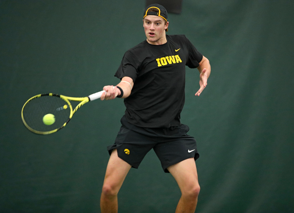 Iowa’s Joe Tyler hits a shot during his match against Marquette at the Hawkeye Tennis and Recreation Complex in Iowa City on Saturday, January 25, 2020. (Stephen Mally/hawkeyesports.com)