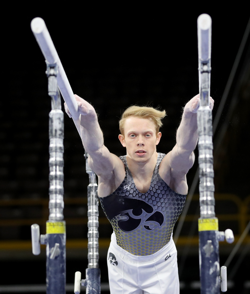 Iowa’s Nick Merryman competes on the parallel bars against Illinois Sunday, March 1, 2020 at Carver-Hawkeye Arena. (Brian Ray/hawkeyesports.com)