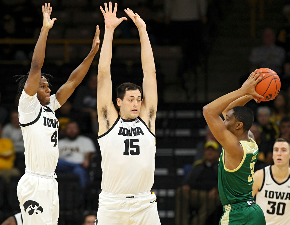 Iowa Hawkeyes guard Bakari Evelyn (4) and forward Ryan Kriener (15) pressure Cal Poly Mustangs guard Colby Rogers (3) during the first half of their game at Carver-Hawkeye Arena in Iowa City on Sunday, Nov 24, 2019. (Stephen Mally/hawkeyesports.com)
