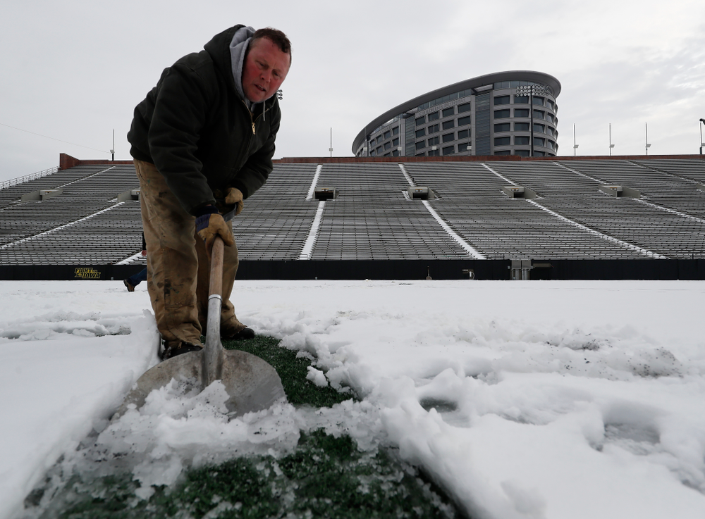 Members of the Iowa Athletics Turf Management staff create the #SnowWave for kids in the Stead Family Children's Hospital Thursday, February