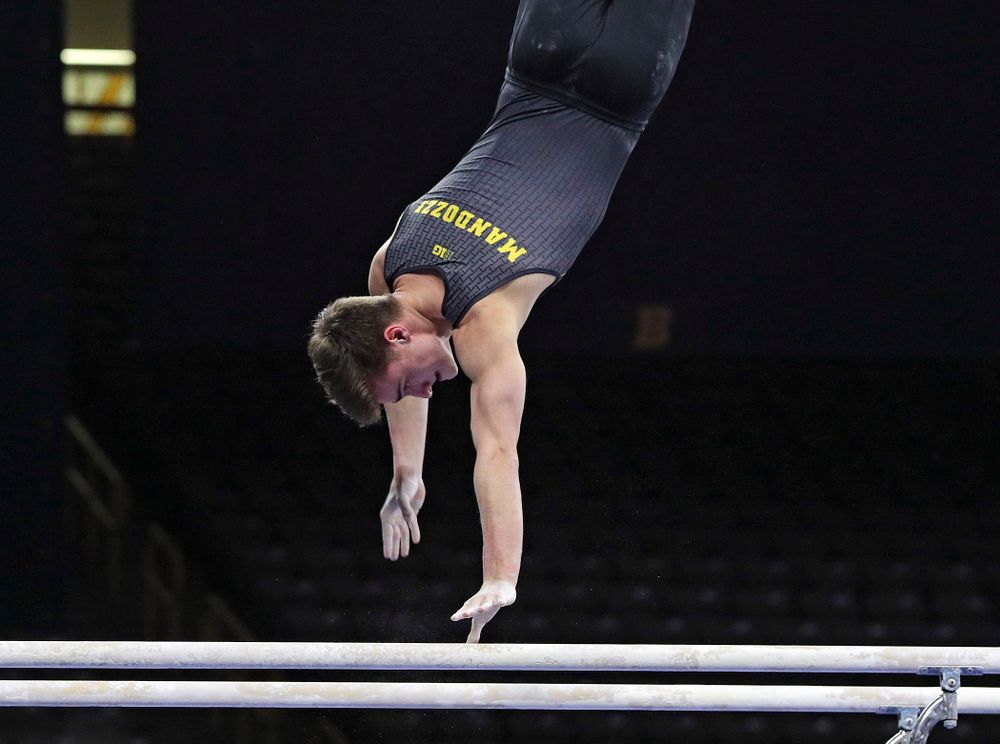 Iowa's Mitch Mandozzi competes in the parallel bars during the first day of the Big Ten Men's Gymnastics Championships at Carver-Hawkeye Arena in Iowa City on Friday, Apr. 5, 2019. (Stephen Mally/hawkeyesports.com)