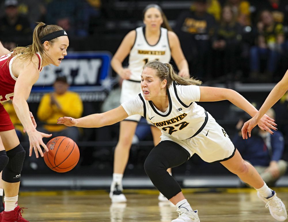 Iowa Hawkeyes guard Kathleen Doyle (22) tries to knock the ball away from Indiana Hoosiers forward Brenna Wise (50) during the first quarter of their game at Carver-Hawkeye Arena in Iowa City on Sunday, January 12, 2020. (Stephen Mally/hawkeyesports.com)