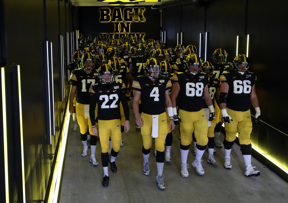 The Iowa Hawkeyes swarm to the field for their game against the Purdue Boilermakers Saturday, October 19, 2019 at Kinnick Stadium. (Brian Ray/hawkeyesports.com)