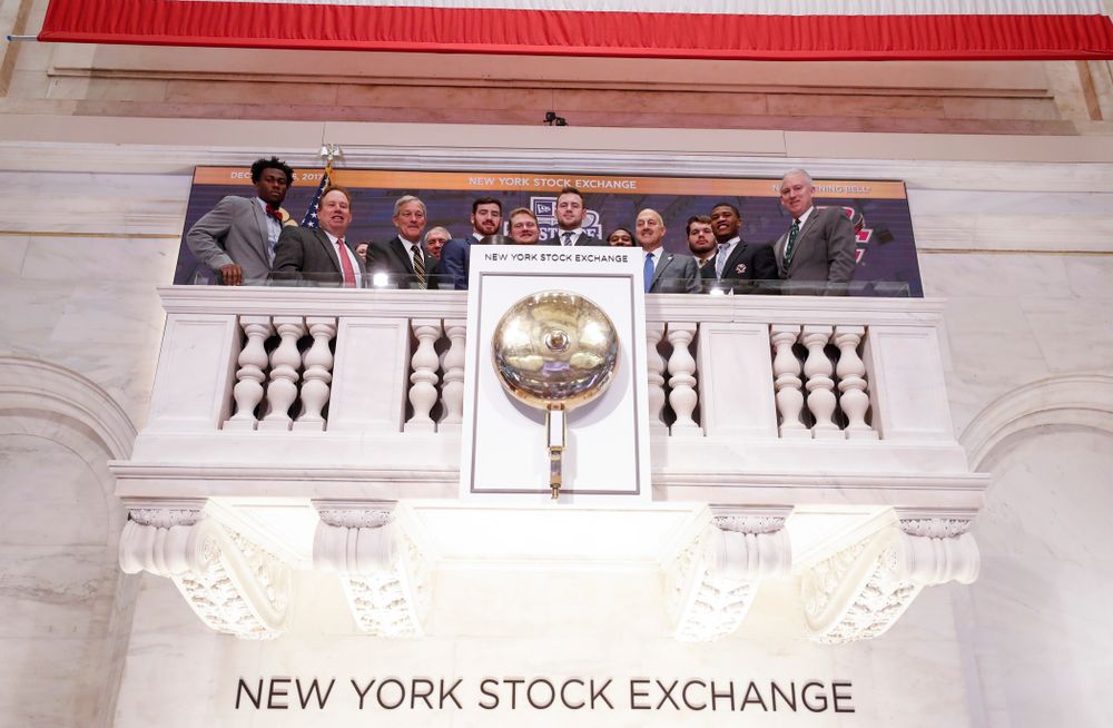 Iowa Hawkeyes linebacker Josey Jewell (43), defensive back Joshua Jackson (15), offensive lineman Sean Welsh (79) and head coach Kirk Ferentz ring the opening bell at the New York Stock Exchange Tuesday, December 26, 2017 in New York. (Brian Ray/hawkeyesports.com)
