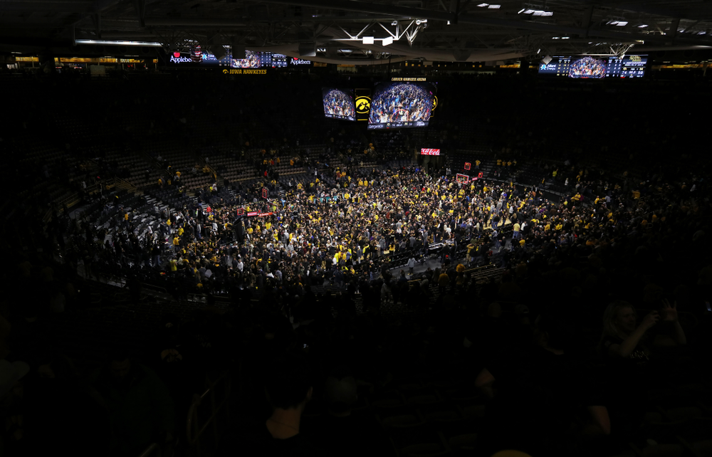 Fans storm the court after Iowa Hawkeyes defeated the Michigan Wolverines Friday, February 1, 2019 at Carver-Hawkeye Arena. (Brian Ray/hawkeyesports.com)