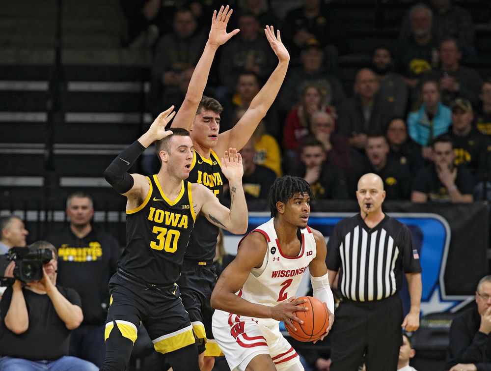 Iowa Hawkeyes guard Connor McCaffery (30) and center Luka Garza (55) pressure Wisconsin Badgers forward Aleem Ford (2) during the first half of their game at Carver-Hawkeye Arena in Iowa City on Monday, January 27, 2020. (Stephen Mally/hawkeyesports.com)