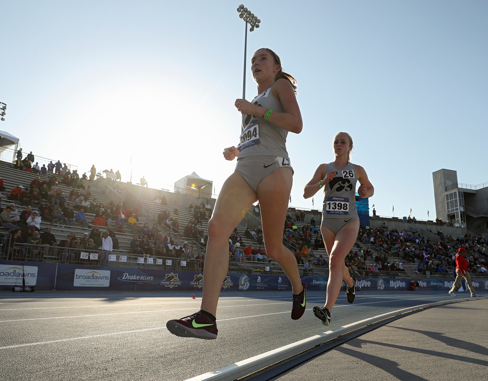 Iowa's Jessica McKee (left) and Kylie Latham (right) run the women's 10,000 meter event during the first day of the Drake Relays at Drake Stadium in Des Moines on Thursday, Apr. 25, 2019. (Stephen Mally/hawkeyesports.com)