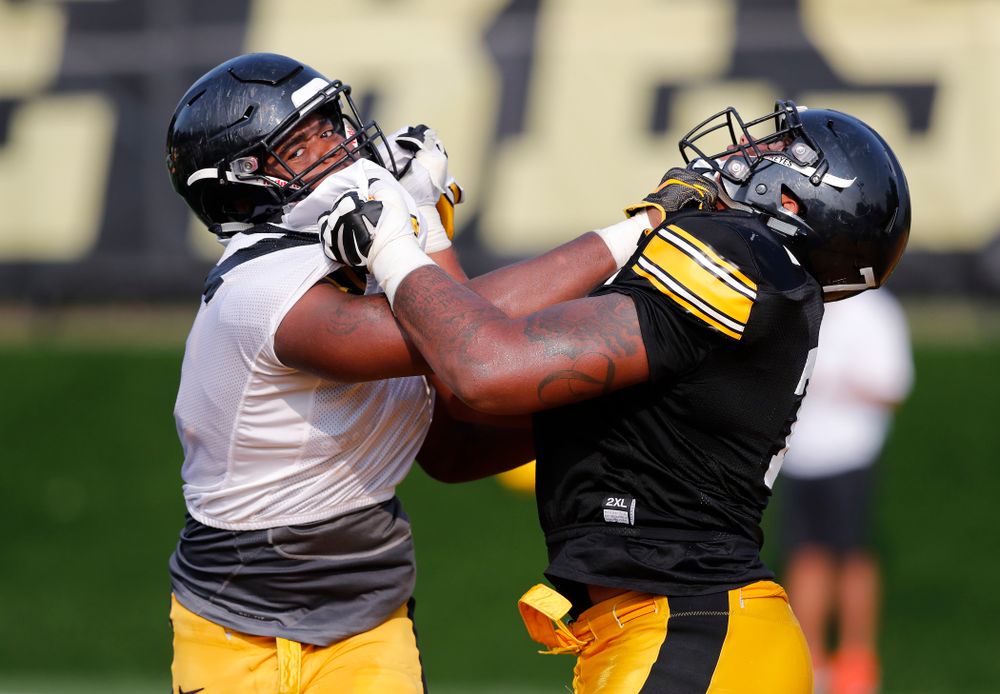 Iowa Hawkeyes defensive end Chauncey Golston (57) and offensive lineman Tristan Wirfs (74) during camp practice No. 16 Tuesday, August 21, 2018 at the Hansen Football Performance Center. (Brian Ray/hawkeyesports.com)