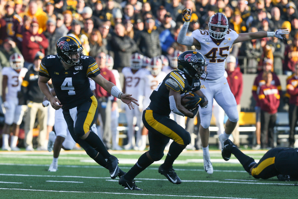 Iowa Hawkeyes quarterback Nate Stanley (4) and Iowa Hawkeyes running back Tyler Goodson (15) during Iowa football vs Minnesota on Saturday, November 16, 2019 at Kinnick Stadium. (Lily Smith/hawkeyesports.com)