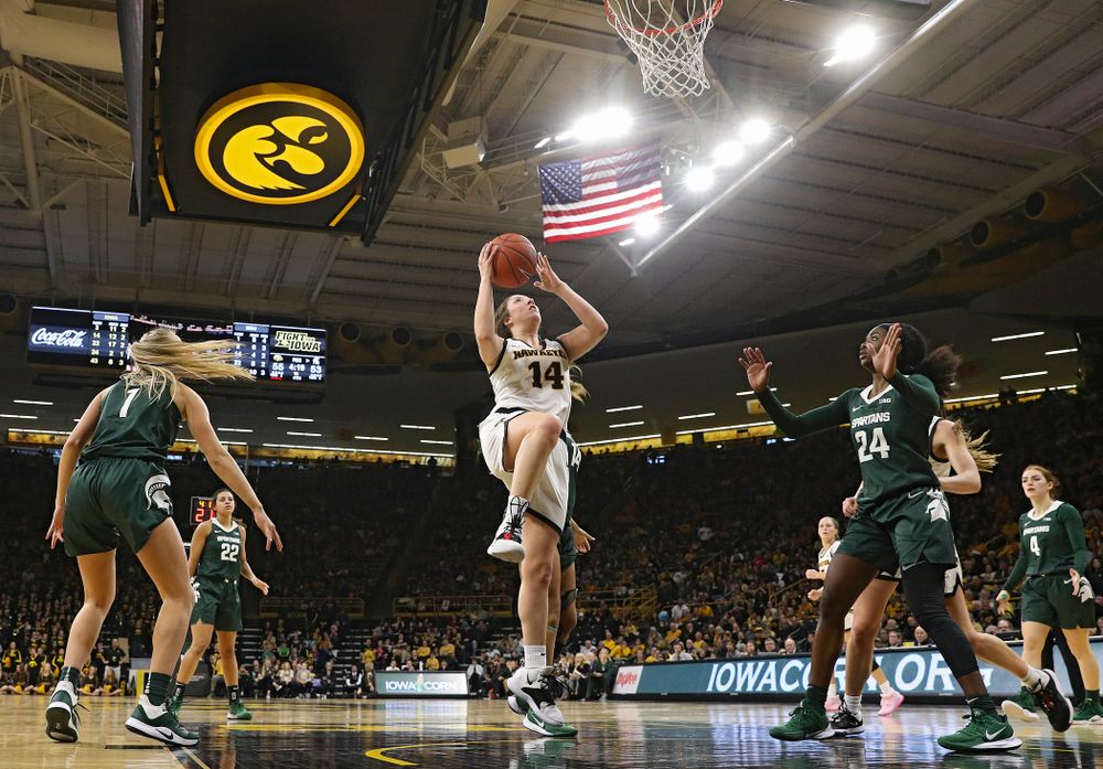 Iowa Hawkeyes guard Mckenna Warnock (14) scores a basket during the fourth quarter of their game at Carver-Hawkeye Arena in Iowa City on Sunday, January 26, 2020. (Stephen Mally/hawkeyesports.com)