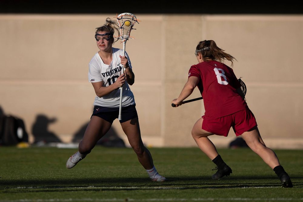STANFORD, California - FEBRUARY 14: Virginia Cavaliers midfield Ashlyn McGovern (16) is defended by Stanford Cardinal defense Kyra Pelton (8) during the second half at Cagan Stadium on February 14, 2020 in Stanford, California. The Virginia Cavaliers defeated the Stanford Cardinal 12-11. (Photo by Jason O. Watson)