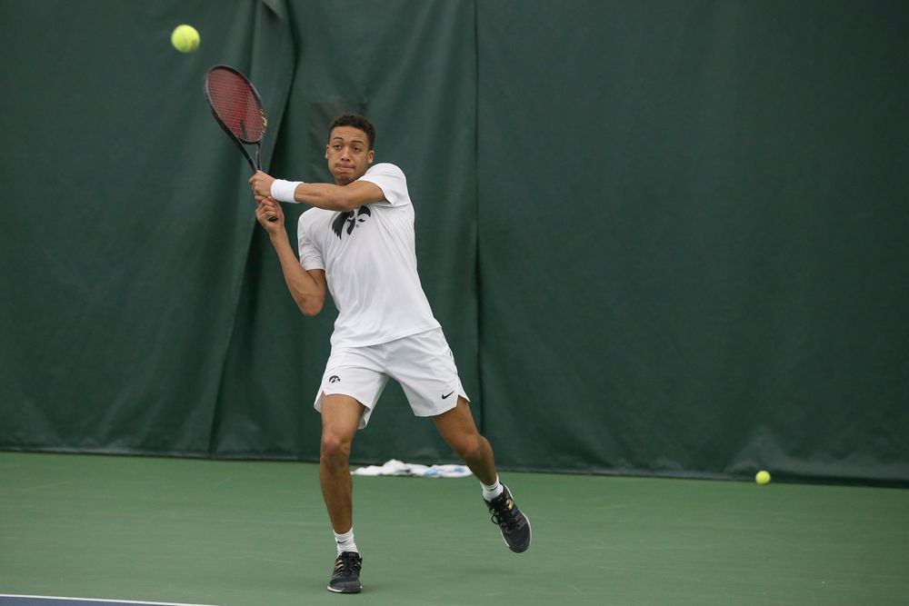 Iowa’s Oliver Okonkwo returns a hit during the Iowa men’s tennis meet vs Nebraska on Sunday, March 1, 2020 at the Hawkeye Tennis and Recreation Complex. (Lily Smith/hawkeyesports.com)