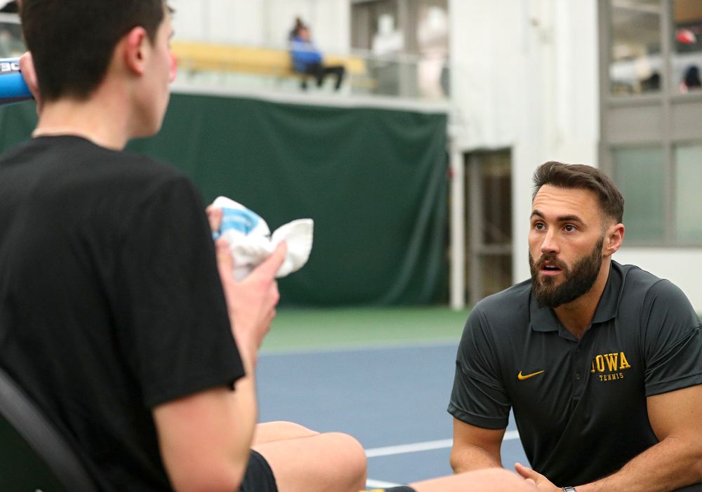 Iowa assistant coach Lloyd Bruce-Burgess (right) talks with Matt Clegg during his doubles match at the Hawkeye Tennis and Recreation Complex in Iowa City on Friday, February 14, 2020. (Stephen Mally/hawkeyesports.com)