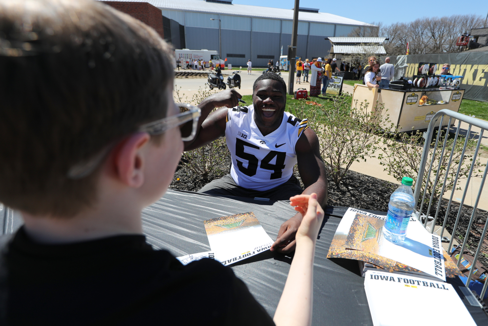 Members of the Iowa Football team sign autographs before the Iowa Hawkeyes game against the Nebraska Cornhuskers Saturday, April 20, 2019 at Duane Banks Field. (Brian Ray/hawkeyesports.com)
