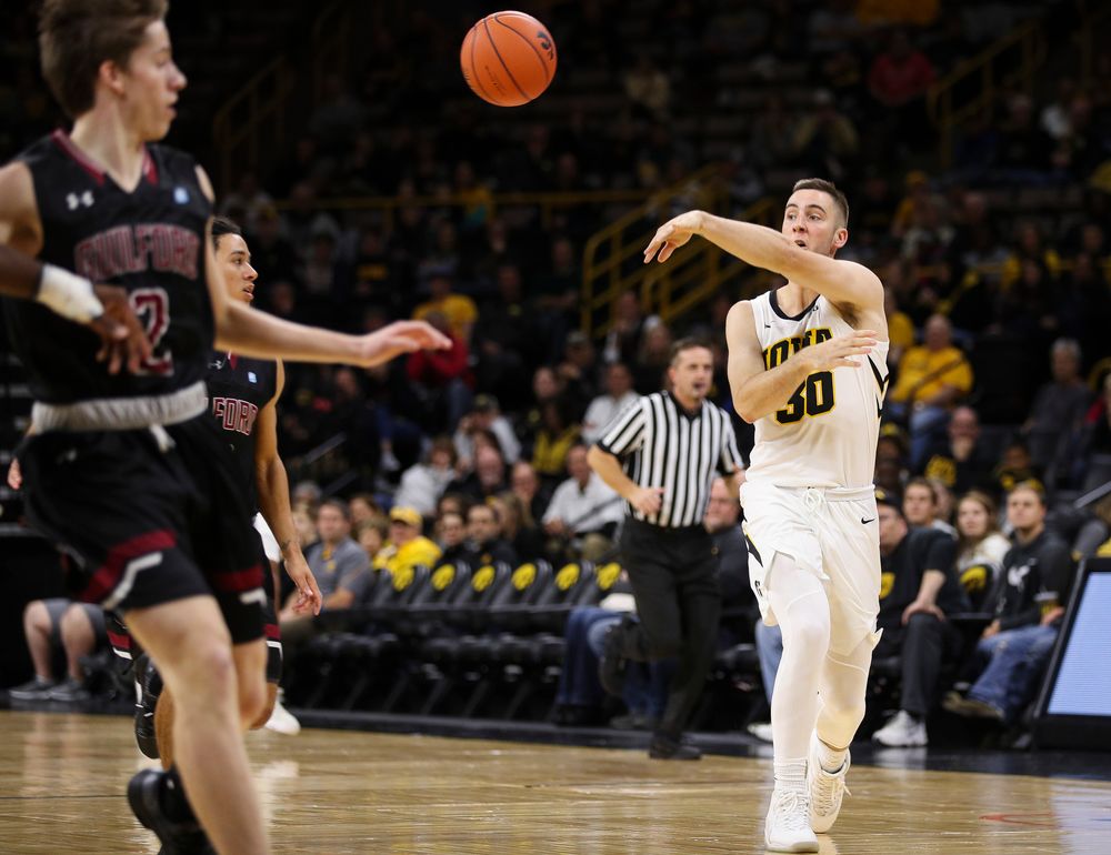Iowa Hawkeyes guard Connor McCaffery (30) passes the ball during a game against Guilford College at Carver-Hawkeye Arena on November 4, 2018. (Tork Mason/hawkeyesports.com)