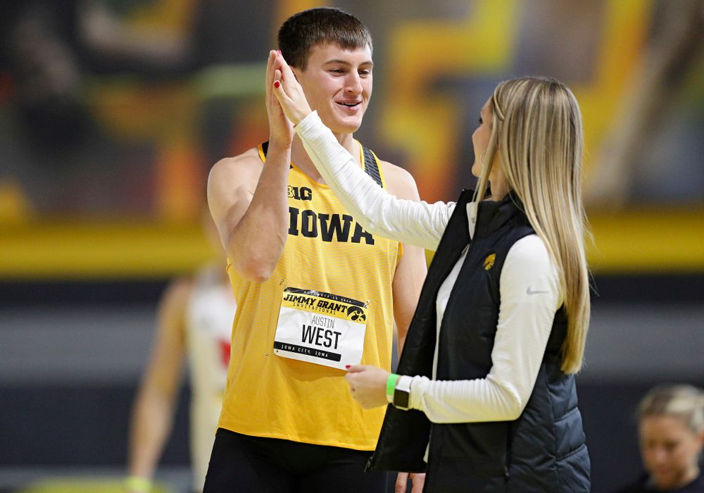 Iowa’s Austin West (from left) gets a high-five from assistant coach Paige Knodle as he competes in the men’s high jump event during the Jimmy Grant Invitational at the Recreation Building in Iowa City on Saturday, December 14, 2019. (Stephen Mally/hawkeyesports.com)
