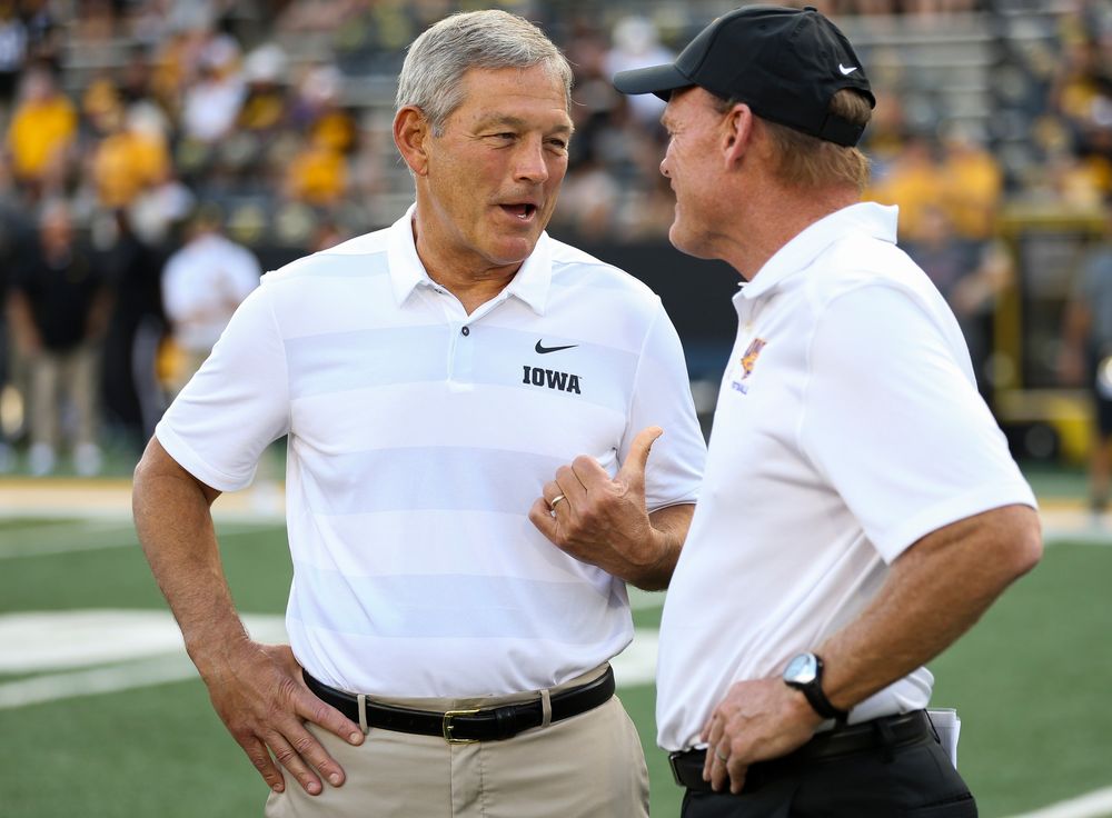 Iowa Hawkeyes head coach Kirk Ferentz and Northern Iowa head coach Mark Farley talk before a game against Northern Iowa at Kinnick Stadium on September 15, 2018. (Tork Mason/hawkeyesports.com)