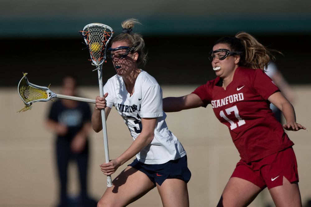 STANFORD, California - FEBRUARY 14: Virginia Cavaliers defense Ashley Stilo (31) is defended by Stanford Cardinal attack Katherine Gjertsen (17) during the first half at Cagan Stadium on February 14, 2020 in Stanford, California. The Virginia Cavaliers defeated the Stanford Cardinal 12-11. (Photo by Jason O. Watson)