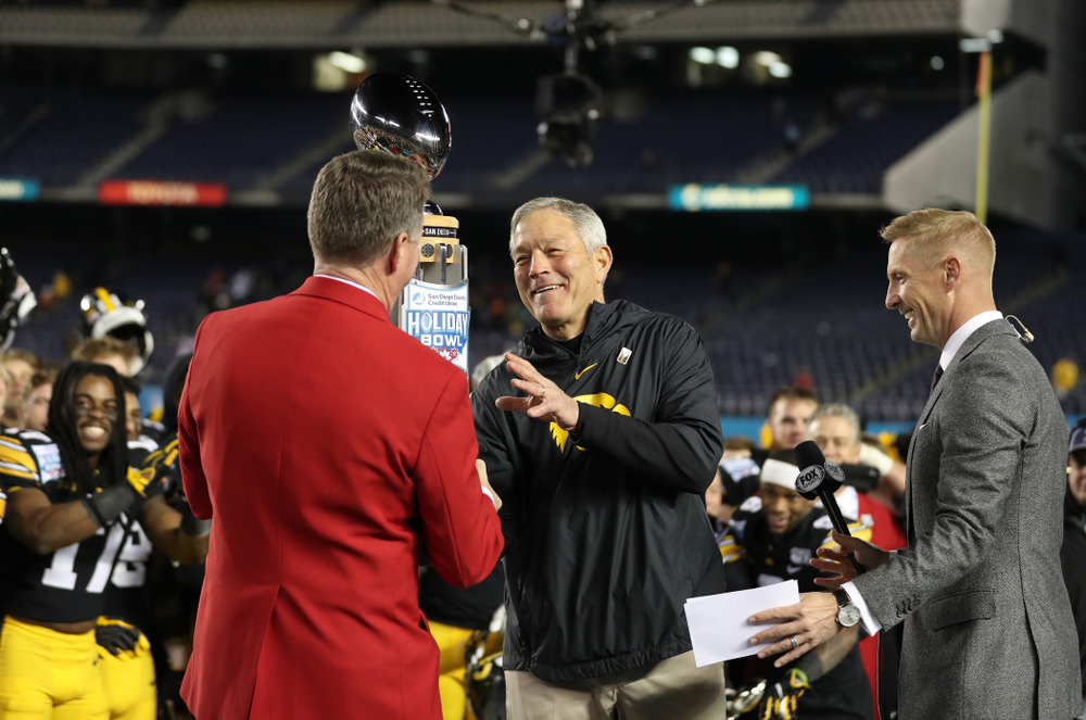 Iowa Hawkeyes head coach Kirk Ferentz is presented with the Holiday Bowl trophy following their win against USC in the Holiday Bowl Friday, December 27, 2019 at San Diego Community Credit Union Stadium. (Brian Ray/hawkeyesports.com)