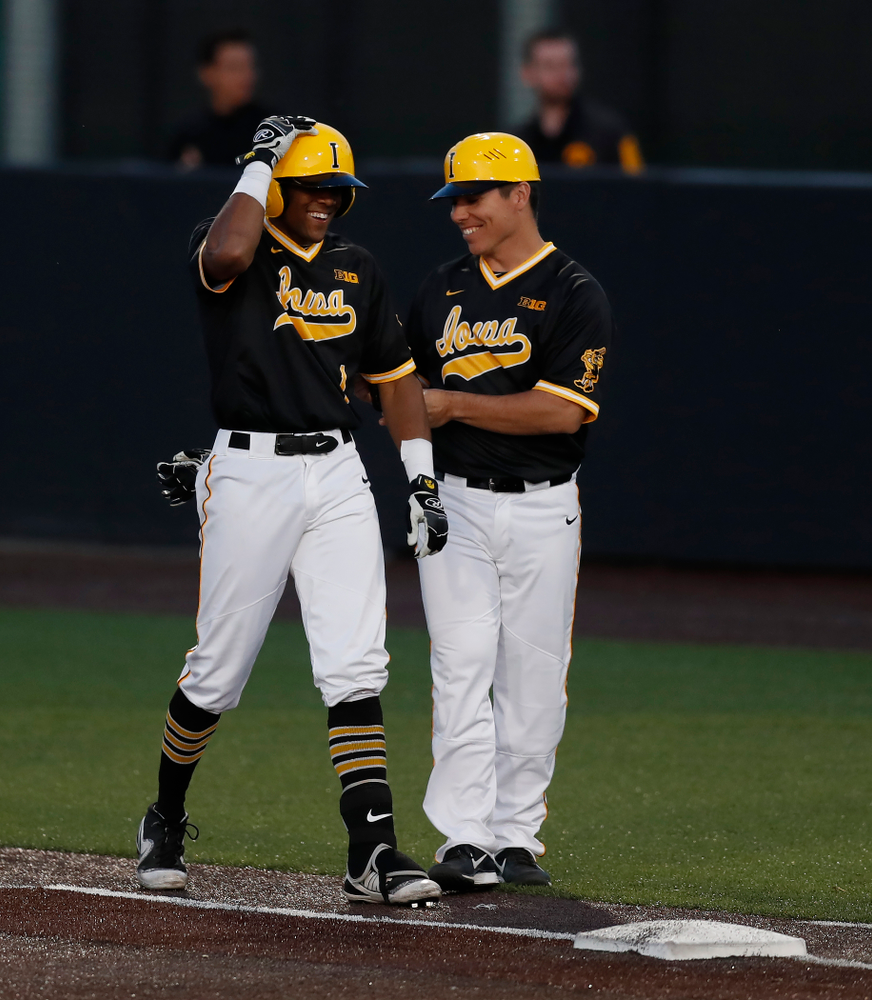 Iowa Hawkeyes third baseman Lorenzo Elion (1) and volunteer coach Sean Moore against Milwaukee Wednesday, April 25, 2018 at Duane Banks Field. (Brian Ray/hawkeyesports.com)
