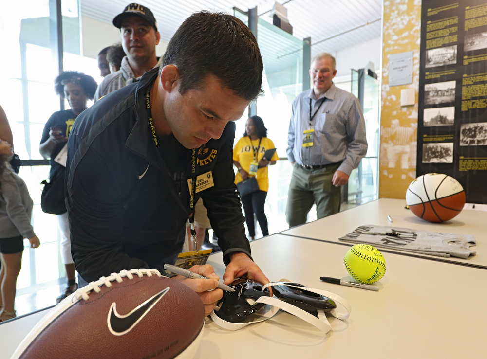 2019 University of Iowa Athletics Hall of Fame inductee Eric Juergens signs a wrestling headgear at the University of Iowa Athletics Hall of Fame in Iowa City on Friday, Aug 30, 2019. (Stephen Mally/hawkeyesports.com)