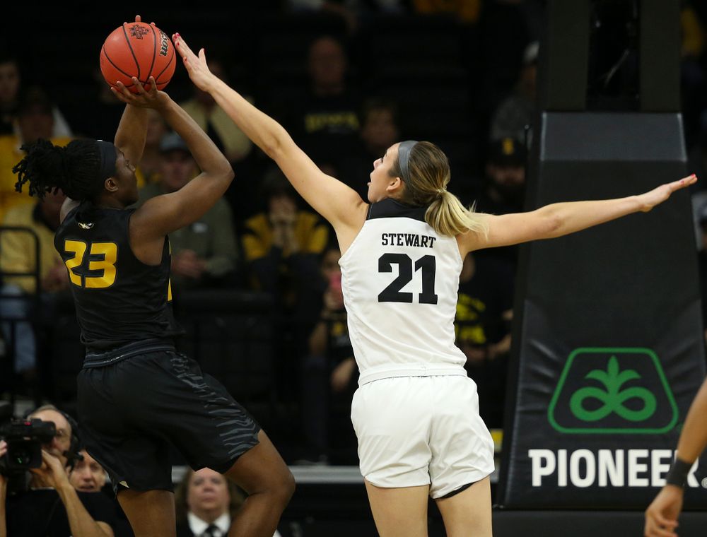 Iowa Hawkeyes forward Hannah Stewart (21) tries to get her hand on a shot by Missouri Tigers guard Amber Smith (23) during the first quarter of their second round game in the 2019 NCAA Women's Basketball Tournament at Carver Hawkeye Arena in Iowa City on Sunday, Mar. 24, 2019. (Stephen Mally for hawkeyesports.com)