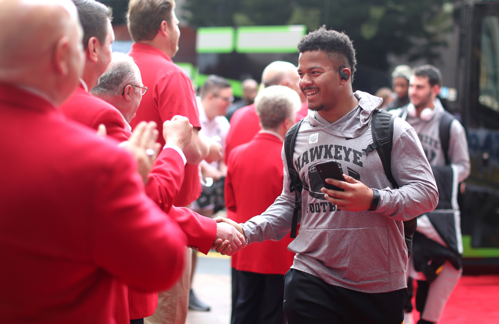 Iowa Hawkeyes running back Ivory Kelly-Martin (21) shakes hands with the ÒRed CoatsÓ after arriving in San Diego, CA Saturday, December 21, 2019 for the Holiday Bowl. (Brian Ray/hawkeyesports.com)