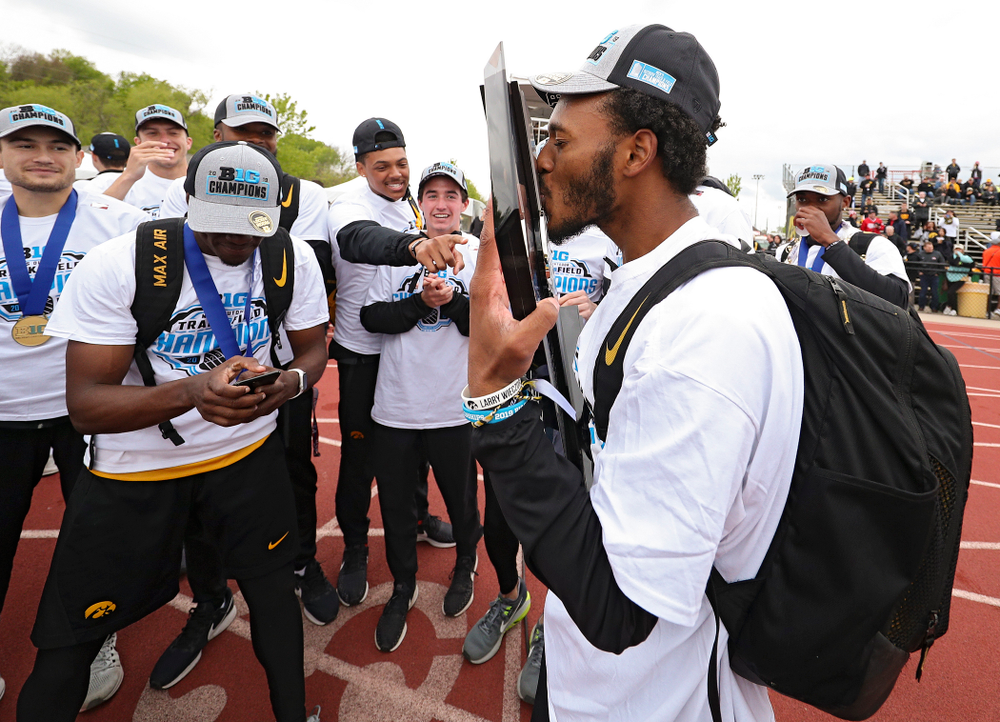 Iowa's Mar’yea Harris kisses their team trophy as he celebrates with teammates after winning the Men's Big Ten Outdoor Track and Field Championships on the third day of the Big Ten Outdoor Track and Field Championships at Francis X. Cretzmeyer Track in Iowa City on Sunday, May. 12, 2019. (Stephen Mally/hawkeyesports.com)